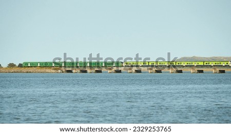 View from sea on the Malahide Bridge, railroad bridge with Dart train passing.