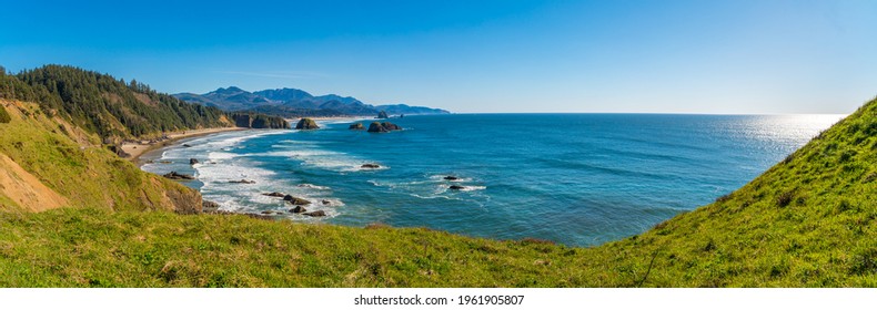 View Of Sea Stack Rocks Along The Pacific Northwest Ocean Coast On A Clear, Sunny Day.