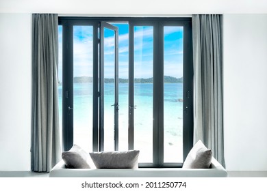 view seascape beautiful tropical beach and blue sky sea and sky, thailand  from black Aluminum door with glass frame and wall in luxury resort