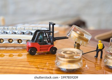 View Of A Section Of An Electric Guitar Where Miniature Figures Workers Dismantle A Rotary Knob With A Fork Lift Truck