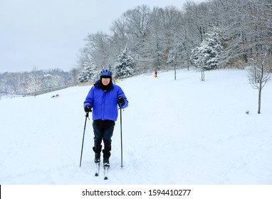 View Of Senior Man Skier With Snow Covered Woods In Background; Winter In Missouri, Midwest