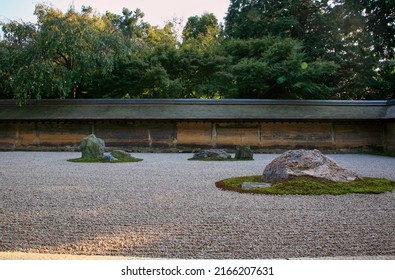 The View Of Separate Groups Of Boulders Surrounded By The Waves Of White Gravel In The Famous Stone Zen Garden Of Ryoan-ji Temple. Kyoto. Japan