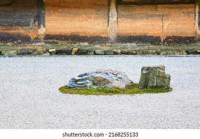 The View Of Separate Groups Of Boulders Surrounded By The Waves Of White Gravel In The Famous Stone Zen Garden Of Ryoan-ji Temple. Kyoto. Japan