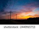 a view set in the sunset with a telephone pole