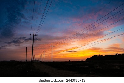 a view set in the sunset with a telephone pole