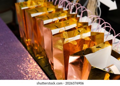 A view of several golden goodie bags on a table, seen at a reception event. - Shutterstock ID 2026376906