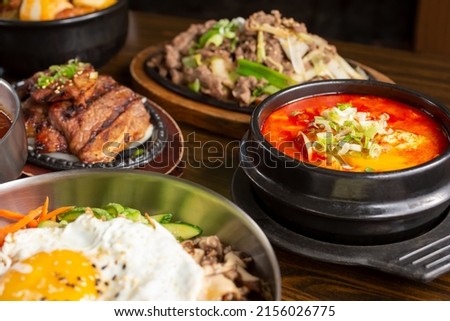 A view of several Korean entrees on the table.