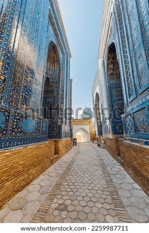 View of the Shah-i-Zinda Ensemble in Samarkand, Uzbekistan. Mausoleums decorated by blue tiles with designs. The necropolis is a popular tourist attraction of Central Asia.