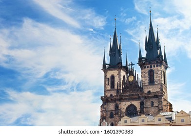 View of the sharp towers of the Church of Mother of God before Týn against vibrant blue sky and white couds. Prague, Chezh Republic