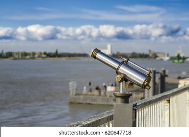 View of the Shelda River from the viewing platform of the wharf of Antwerp. Telescope with landscape