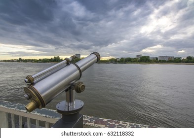 View of the Shelda River from the viewing platform of the wharf of Antwerp. Telescope with landscape