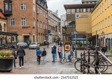  View of shopping street with shops and people in downtown of Uppsala. Sweden. Uppsala. 05.14.2022.