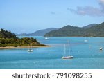 View of Shute Harbour, islands and Conway National Park, from the mainland at Shute Haven, The Whitsundays, Australia.  Sailing yachts moored. Tropical climate. The Tropics. Copy space. 