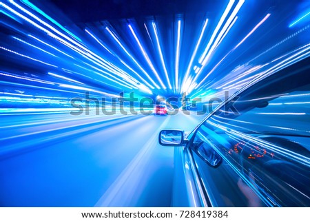 View from Side of Car moving in a night city, Blured road with lights with car on high speed.