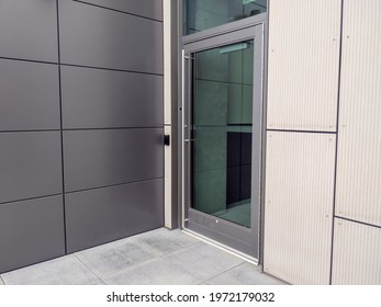 View of a side entrance door for a business building with a keyless entry box on the side.