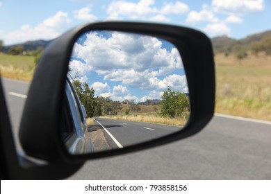 View In The Side Mirror Of The Road And Country Side In Rural New South Wales Bylong Valley - Australia. This Area Has Quiet Country Roads, Farmland And National Parks And Great For A Road Trip.