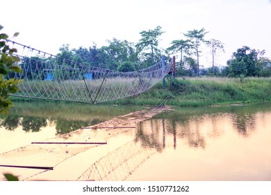 View Of The Side Of Rope Bridge Across The Canal