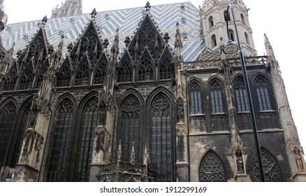 View Of The Side Wall Of An Ancient Temple. St. Stephen's Cathedral In Vienna. The Old Building In The Gothic Style Is A Masterpiece Of Austrian Culture And The Main Attraction Of The Capital.