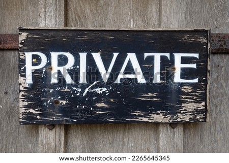 View of a sign reading 'private' on an old oak door