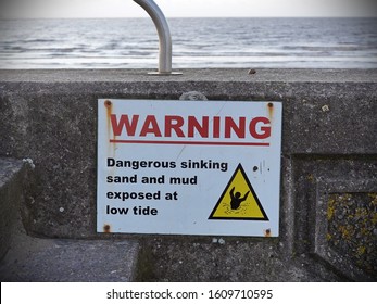 View Of A Sign Warning Against Sinking Sand