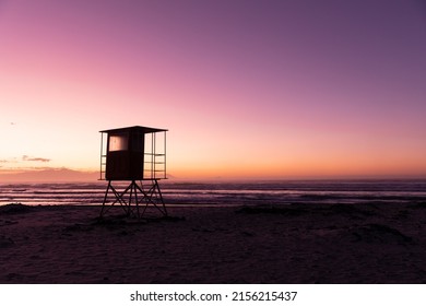 View of silhouette lifeguard hut at sandy beach against scenic view of sea and clear purple sky. copy space, unaltered, nature and protection concept. - Powered by Shutterstock