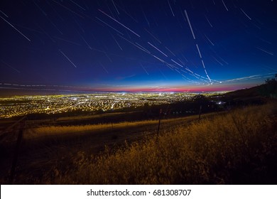 View Of The Silicon Valley From Mount Hamilton At Night With Stars And Plane Trails.