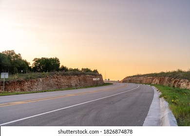 View of Single Lane Highway Going up a Hill In the Early Morning Hours in Texas
