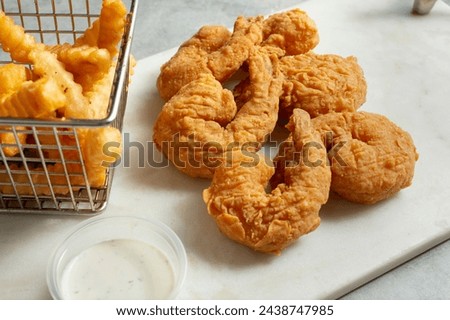 A view of six deep fried jumbo shrimp.