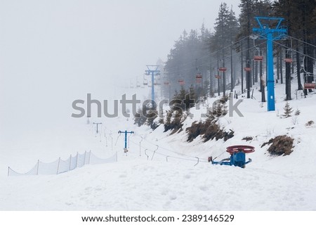 A view from the skiing slope in Dragobrat, Ukraine. View of the chairlift in the fog.