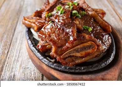 A View Of A Skillet Plate Of Galbi, Which Is Marinated Korean Beef Short Rib.