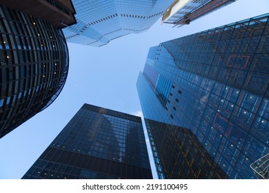 View to the sky between high-rise buildings skyscrapers as a concept for business banks wall street and stock market
