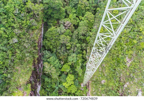 View from\
the sky bridge walking platform, about 40m drop. Showing part of\
the single pylon supporting the\
platform.
