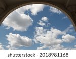 view of the sky with clouds from the arch of a tall building. selective focus. High quality photo