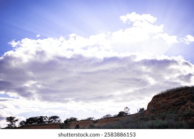 view of the sky from a hill, a large cloud above the hill.