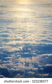 A view from the sky. An image of some clouds against the sea taken from up high. The focus point is on the sea surface. Image also has a vintage effect applied.