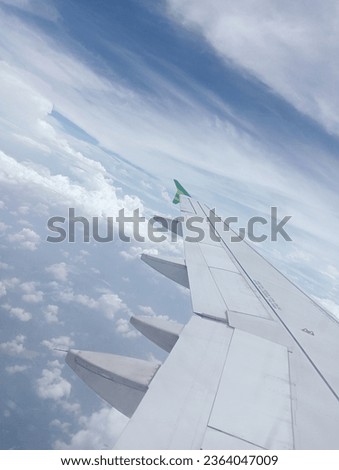 View of the sky with white clouds from the window of an airplane at a height of several feet above sea level