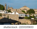 view of the skyline of the city of Úbeda with several churches on top of the white houses, with tiled roofs next to various walks and avenues on the gardens and parks that surround the city