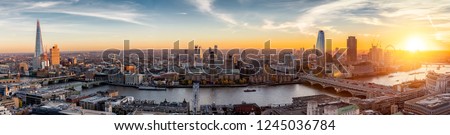 View to the skylne of London along the Thames river during sunset time, United Kingdom