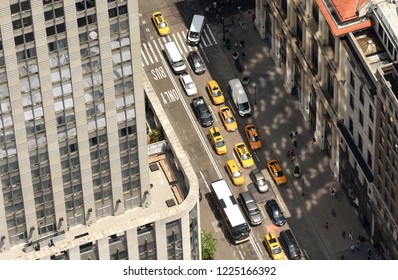 View From Skyscrapers On The Streets Of New York City. Top View On The Street With Cars On The Road. Yellow Taxi Cabs In New York City