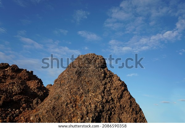 View of slag heaps of iron ore quarry. Mining\
industry. Slag Coal Burnt out, Texture heap top view. Nature rock\
Red Background spent coal.