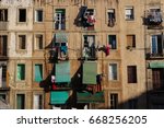 View of slum apartments with blinds and balconies in the Raval district, Barcelona, Spain.