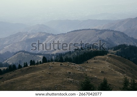 “Panoramic View of the Small Almaty Ring Trail with Chimbulachka, Bashuta, Panarama and Furmanovka Peaks”
