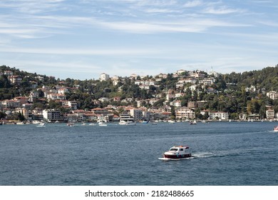 View Of A Small Boat On Bosphorus And Bebek Neighborhood On European Side Of Istanbul. It Is A Sunny Summer Day. Beautiful Travel Scene.