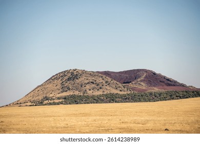 View of a small extinct cinder cone volcano south of Capulin Volcano National Monument in the Raton-Clayton Volcanic Field. (Photo by Gunnar Rathbun)
