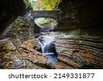 A view to small fall under bridge in gorge in Watkins Glen State Park, Finger Lakes, USA