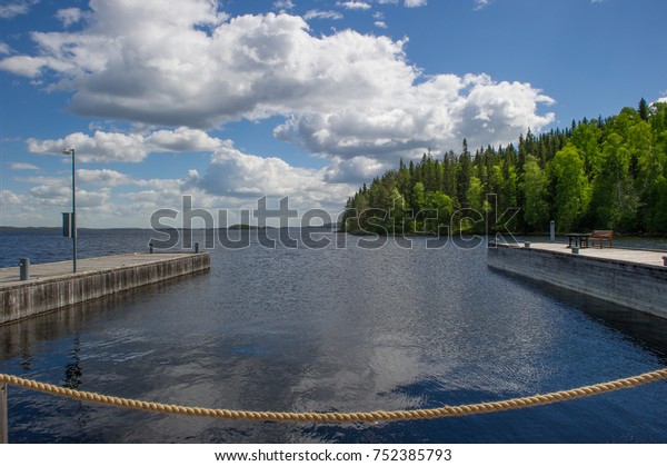 a view of\
small harbor with tow docks on the\
lake
