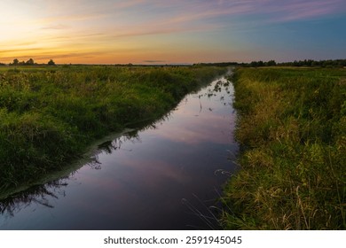 A view of a small, quiet river in eastern Poland during sunset