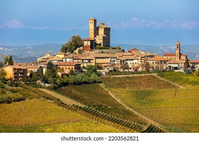 View of small town on the hill with colorful autumnal vineyards in Piedmont, Northern Italy. - Shutterstock ID 2203562821