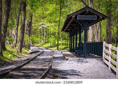 A View Of A Small Train Station In The Middle Of Rural America On A Sunny Day