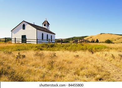 View of a small wooden pioneer church in the prairies during autumn